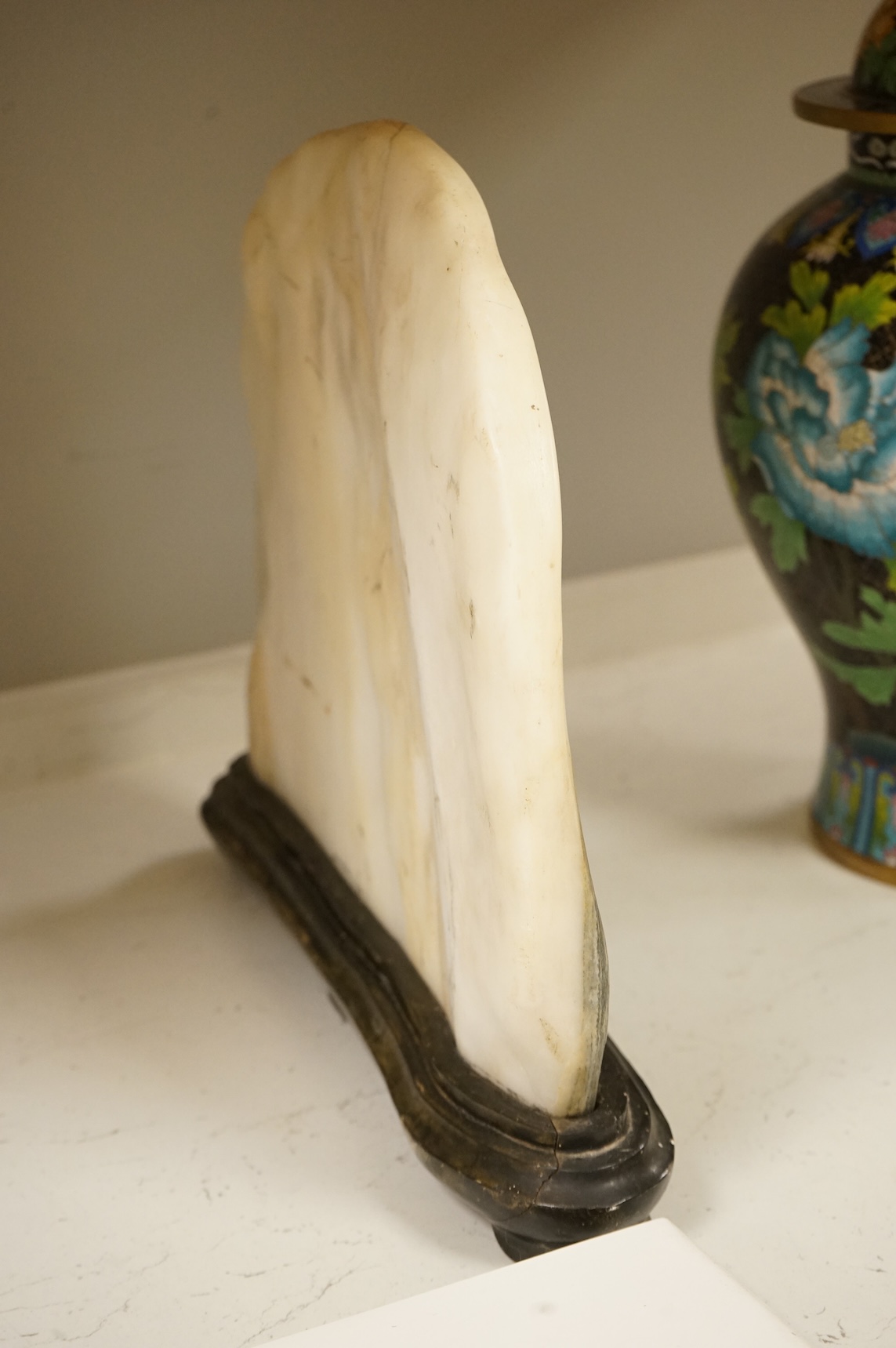 A Chinese dreamstone carving on stand, 38cm wide
